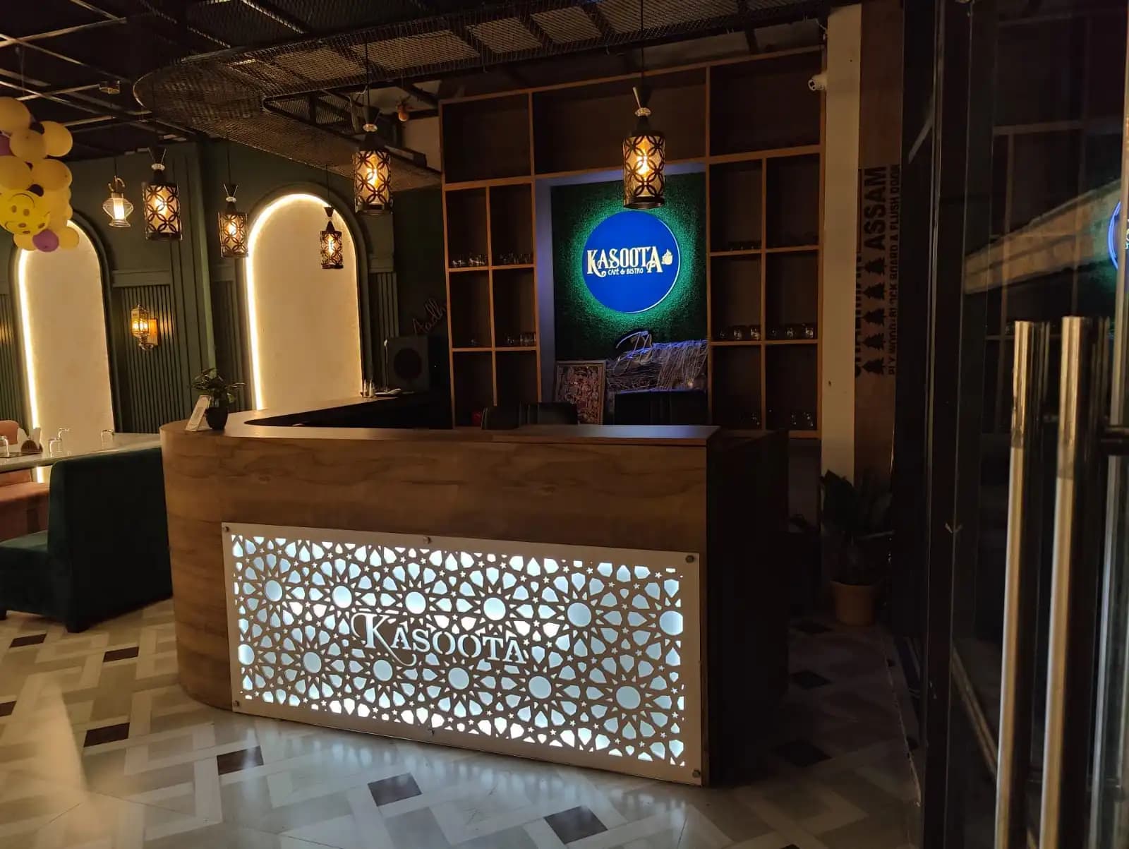 Kasoota Café & Bistro's host counter and jaali-lattice signage, Ayodhya